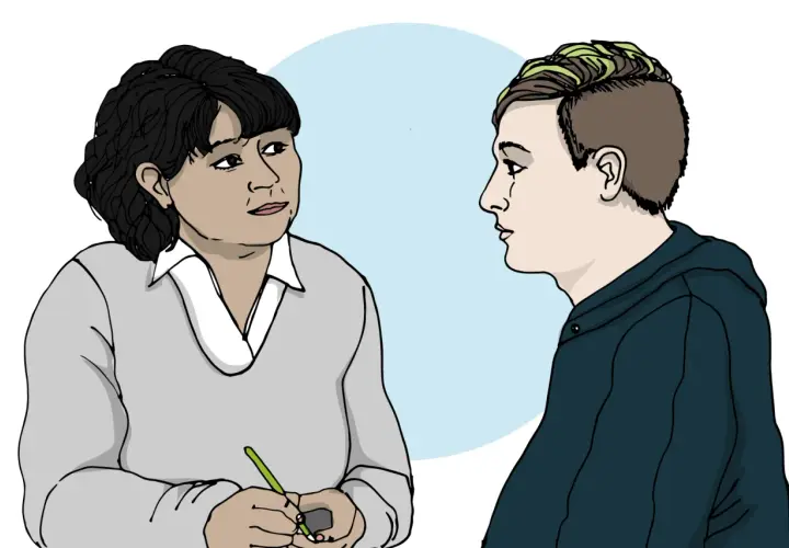 En person med mörk frisyr och en person med grönfärgat hår pratar. En av dem skriver, kanske om ett anorexia symptom.