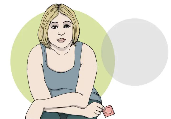 En kvinna med blont hår håller ett kondom. Hon ser orolig ut, kanske på grund av ett möjligt hiv symptom.