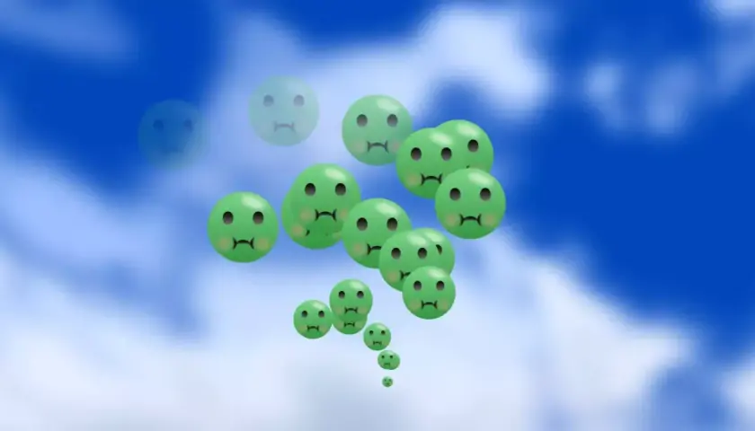 Gröna, ledsna smileys svävar i en blå himmel. Kanske en bild som symboliserar behovet av medicin mot illamående.