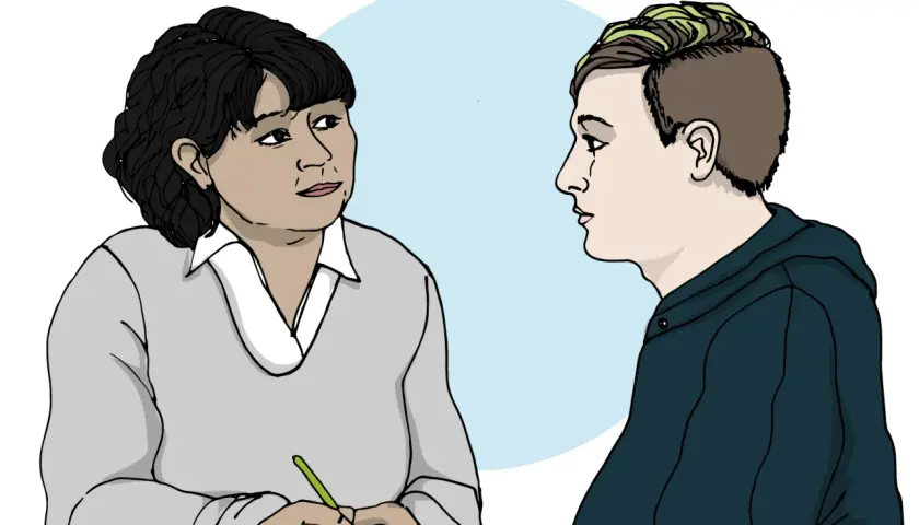 En person med mörk frisyr och en person med grönfärgat hår pratar. En av dem skriver, kanske om ett anorexia symptom.