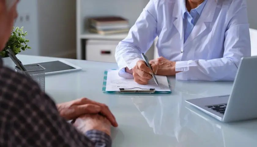 Läkare skriver ner patientens upplevelser av immunterapi biverkningar.