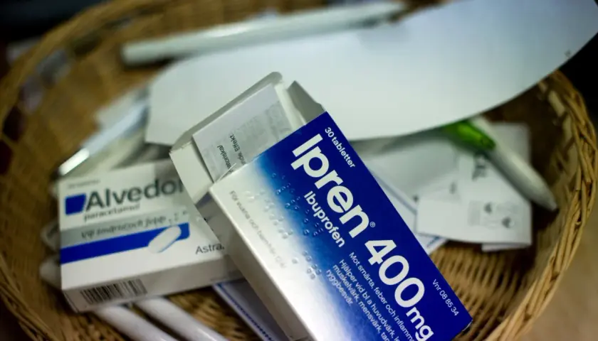 Ipren och Alvedon, två vanliga antiinflammatoriska mediciner, ligger i en korg med papper och pennor.