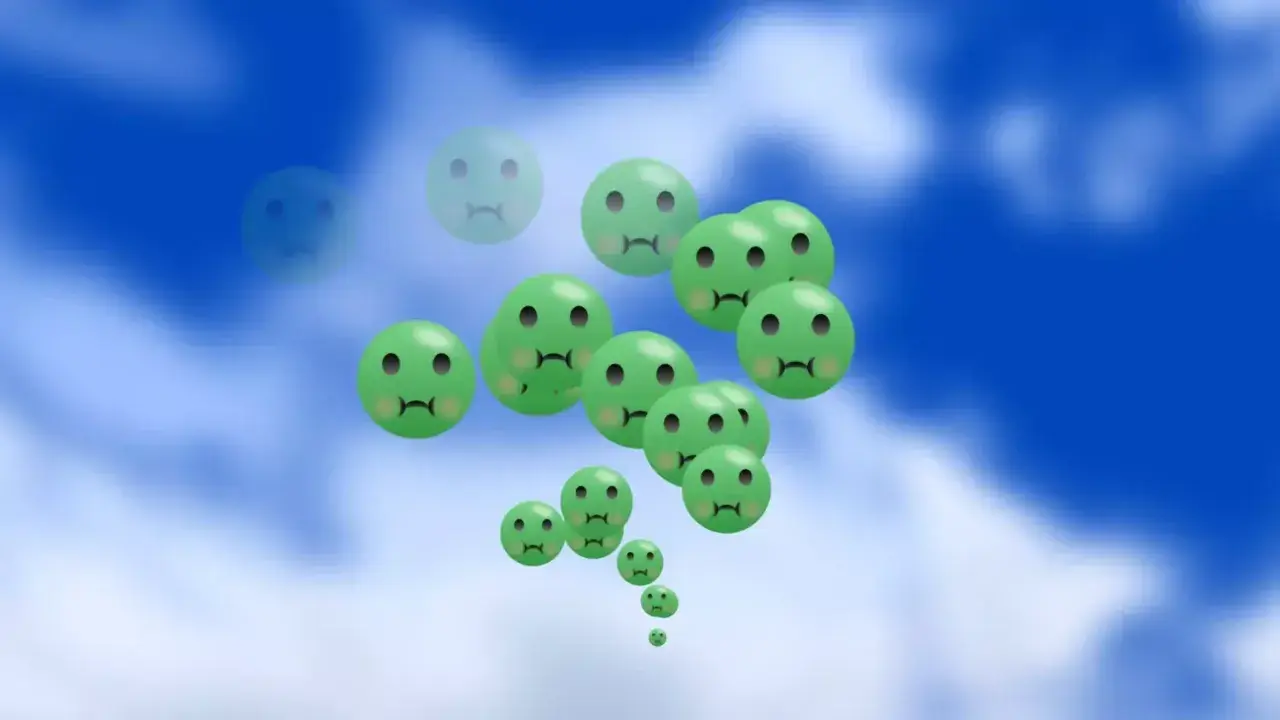 Gröna, ledsna smileys svävar i en blå himmel. Kanske en bild som symboliserar behovet av medicin mot illamående.